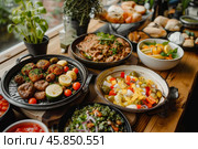 Delicious mediterranean dishes served on a buffet table for a catered event. Стоковое AI-изображение, AI-художник Иван Рябоконь / Фотобанк Лори
