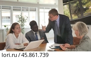 Angry middle-aged man shouting at his business partners sitting around table in conference room. Стоковое видео, видеограф Яков Филимонов / Фотобанк Лори