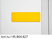 Bright yellow rectangular label on a plain white background perfect for organizational tasks or labeling items indoors. Стоковое фото, фотограф Сергей Толмачёв / Фотобанк Лори