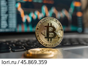 Bitcoin cryptocurrency coin standing on laptop keyboard with charts on screen. Стоковое AI-изображение, AI-художник Иван Рябоконь / Фотобанк Лори