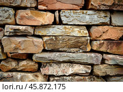 Stone wall showing colorful stratification and rough texture. Стоковое AI-изображение, AI-художник Иван Рябоконь / Фотобанк Лори
