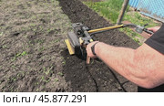 The tractor is used for field cultivation. A tractor pulled by a plow plunges it into the soil. A field devoid of moisture and fertility appears before us. Стоковое видео, видеограф Скрипачев Антон / Фотобанк Лори