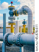 Gas pipeline infrastructure with valves and flanges connecting pipes for energy distribution. Стоковое AI-изображение, AI-художник Юрий Поздников / Фотобанк Лори