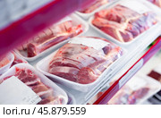 Packaged pork meat laid out on display shelves of butcher store. Стоковое фото, фотограф Яков Филимонов / Фотобанк Лори