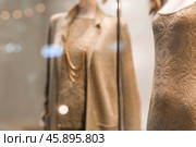 An elegant showcase of an expensive luxury store with stylish mannequins in clothes and evening lighting. The concept of shopping and sales. Стоковое фото, фотограф Photojuli / Фотобанк Лори