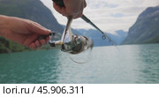 Woman fishing on Fishing rod spinning in Norway. Стоковое видео, видеограф Андрей Армягов / Фотобанк Лори