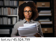 Serious librarian holding documents in library, surrounded by bookshelves. Стоковое AI-изображение, AI-художник Иван Рябоконь / Фотобанк Лори
