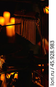 A close-up photo of a drum set with a cymbal and chimes in the foreground. The background is blurred and orange. Стоковое фото, фотограф Воловодов Владимир / Фотобанк Лори