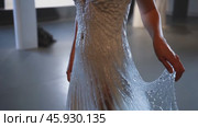 Fashion designer showing innovative waterproof wedding dress. Стоковое видео, видеограф Данил Руденко / Фотобанк Лори