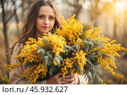 A beautiful girl with a fluffy bouquet of mimosa. Close-up. The concept of spring and International Women's Day on March 8th. Стоковое AI-изображение, AI-художник Photojuli / Фотобанк Лори