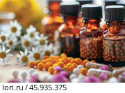 Alternative medicine concept featuring homeopathy globules and essential oils. Стоковое AI-изображение, AI-художник Иван Рябоконь / Фотобанк Лори