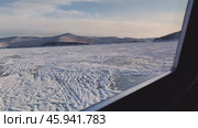 View of Olkhon island from the window, from inside the hovercraft. khivus rushes across the winter frozen lake Baikal, cracked snow ice in winter. slow motion. Стоковое видео, видеограф ЛУНИНА ВЕРОНИКА / Фотобанк Лори