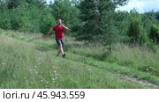 Exploring Nature a Hiker with backpack Strolling Through a Beautiful Field Beneath Vast Blue Sky. Tourist man traverses a scenic field, clear blue sky. Adventure and exploration concept. One person. Стоковое видео, видеограф Марина Демидюк / Фотобанк Лори