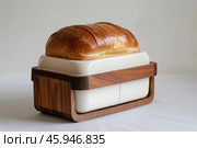 Loaf of freshly baked bread resting in modern breadbox. Стоковое AI-изображение, AI-художник Иван Рябоконь / Фотобанк Лори