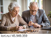 Pension. Saving money. Savings. An elderly couple calculates their savings. Financial literacy. Стоковое AI-изображение, AI-художник Photojuli / Фотобанк Лори