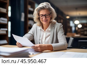 Smiling senior businesswoman reviewing documents at office desk. Стоковое AI-изображение, AI-художник Иван Рябоконь / Фотобанк Лори