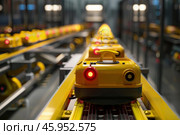 Automated guided vehicles moving on assembly line in factory. Стоковое AI-изображение, AI-художник Иван Рябоконь / Фотобанк Лори