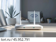 White wi fi router providing wireless internet access in home office. Стоковое AI-изображение, AI-художник Иван Рябоконь / Фотобанк Лори
