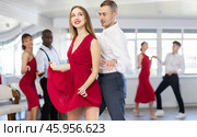 Woman dances incendiary boogie woogie with man partner during choreography lesson. Стоковое фото, фотограф Яков Филимонов / Фотобанк Лори