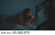 Insomniac woman with phone in her hands lying awake on bed at night. Стоковое видео, видеограф Маргарита Кирьякова / Фотобанк Лори