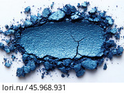 A macro shot of scattered pieces of bright blue glitter pigment or cosmetic powder. The surface of the material has a texture with cracks and unevenness, and the powder itself looks as if it has been slightly crumbled. The glitter particles create a sparkling effect, and the colors range from bright blue to deeper shades, giving the image a vivid and dynamic look. The pigment looks like a precious powder, playing with light, which enhances its appeal. Стоковое AI-изображение, AI-художник Анна Кривицкая / Фотобанк Лори