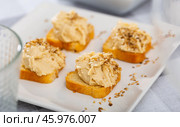 Four hummus sandwiches are laid out on plate - traditional snack of Middle East. Стоковое фото, фотограф Яков Филимонов / Фотобанк Лори
