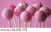 Bright pink lollipops decorated with white and pink dots and lines. These confections are decorated with love and attention to detail. The background is also pink, which creates a harmonious atmosphere and emphasizes the sweetness and playfulness of the image. Lollipops look like a delicious and aesthetically pleasing dessert that can be part of a festive treat. Стоковое AI-изображение, AI-художник Анна Кривицкая / Фотобанк Лори