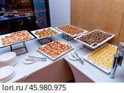 Buffet hotel restaurant, coffee break event food stand on table white tablecloth. Стоковое фото, фотограф Spirit River / Фотобанк Лори