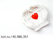 Stylish banner. In his hands, a red heart on a white background is made of plaster. World Health, Love and Insurance Day. World Heart, Health and Organ Donor Day. Стоковое фото, фотограф Photojuli / Фотобанк Лори