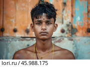 Young hindu devotee posing in front of temple door in tamil nadu, india. Стоковое AI-изображение, AI-художник Иван Рябоконь / Фотобанк Лори