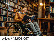 Disability. A child with disabilities in a wheelchair is reading a book in the library. Healthcare and medicine. Стоковое AI-изображение, AI-художник Photojuli / Фотобанк Лори
