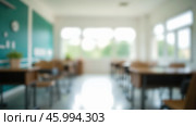Blurred background of modern classroom interior with empty desks, chairs, whiteboard, shelves, educational environment, learning space, school room, quiet study area. Стоковое фото, фотограф Павел Муравьев / Фотобанк Лори