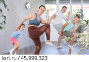 Parents with young daughter and schoolboy son are taught to move to boogie-woogie. Стоковое фото, фотограф Яков Филимонов / Фотобанк Лори