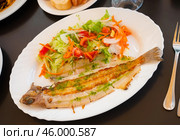 There is plate with fried solea flatfish and salad of fresh veg on wooden table. Стоковое фото, фотограф Яков Филимонов / Фотобанк Лори