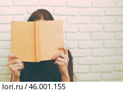 Pretty relaxed young woman reading a book. Стоковое фото, фотограф Сергей Толмачёв / Фотобанк Лори