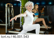Mature woman actively doing Pilates exercises. Стоковое фото, фотограф Яков Филимонов / Фотобанк Лори