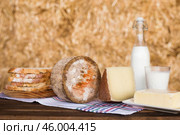 Still life of hard cheese, milk, bread and butter in the hay. Стоковое фото, фотограф Татьяна Яцевич / Фотобанк Лори
