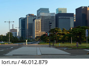 Tokyo, Japan,  11.04.2024: Skyscrapers of the Marunouchi business district in Chiyoda Ward against the background of the Outer gardens of the Imperial Palace on a sunny day. Редакционное фото, фотограф Ula Ulachka / Фотобанк Лори