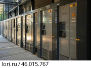 Multiple electric cabinets are powering a building. Стоковое AI-изображение, AI-художник Иван Рябоконь / Фотобанк Лори