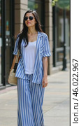 Stylish Summer Outfit Featuring Stripes and Relaxed Fit in Urban Street Setting. Стоковое AI-видео, аниматор Sergey Grishin / Фотобанк Лори
