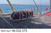 A collection of bright red life jackets is scattered on a wooden deck. Perfect for themes of safety, outdoor activities, and water sports. Стоковое видео, видеограф Ирина Старикова / Фотобанк Лори