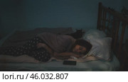 Sleeplessness. Insomniac person can't fall asleep at night, lying awake in bed. Стоковое видео, видеограф Маргарита Кирьякова / Фотобанк Лори