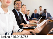 Businessman using laptop during conference in meeting room. Стоковое фото, фотограф Яков Филимонов / Фотобанк Лори