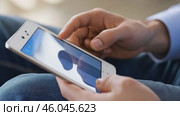 Person using a tablet device. Digital interactions and activities. Man holding a pad. Remote learning, social distance working, ordering buying online, reading e book. Close-Up view, Modern Technology. Стоковое AI-видео, аниматор Марина Демидюк / Фотобанк Лори