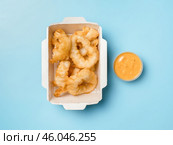 Oven baked breaded calamari rings served with lime wedges, sweet chilli sauce and mayonnaise. Стоковое фото, фотограф Ольга Сергеева / Фотобанк Лори