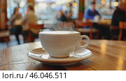 White steaming cup of coffee on table in cafe with people in cafeteria blurred background. Freshly brewed hot latte, cappuccino cup with saucer. Breakfast beverage morning concept. Restaurant drink. Стоковое AI-видео, аниматор Марина Демидюк / Фотобанк Лори