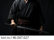 Samurai warrior holding katana sword in traditional clothing. Стоковое AI-изображение, AI-художник Иван Рябоконь / Фотобанк Лори