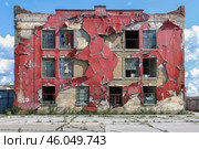 Decaying red paint crumbling off old brick building facade. Стоковое AI-изображение, AI-художник Иван Рябоконь / Фотобанк Лори