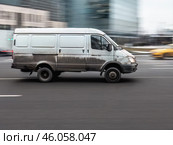 White Gazelle panel van in fast motion on city street. Fast moving cargo car on urban road. Редакционное фото, фотограф Константин Григорьев / Фотобанк Лори