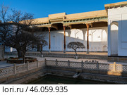 View of the courtyard of the Bahauddin Naqshbandi Memorial Complex with a pond in the foreground on a sunny day, Bukhara, Uzbekistan. Стоковое фото, фотограф Ula Ulachka / Фотобанк Лори